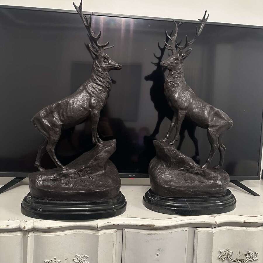 Pair of bronze Highland stags on black marble bases